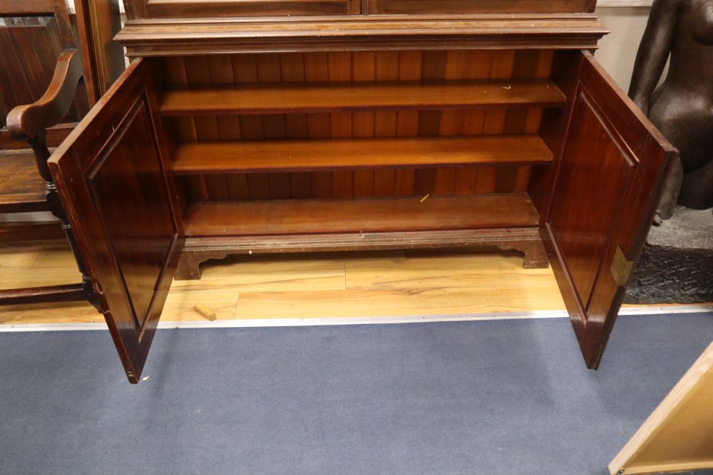 An Edwardian walnut bookcase, width 142cm height 225cm